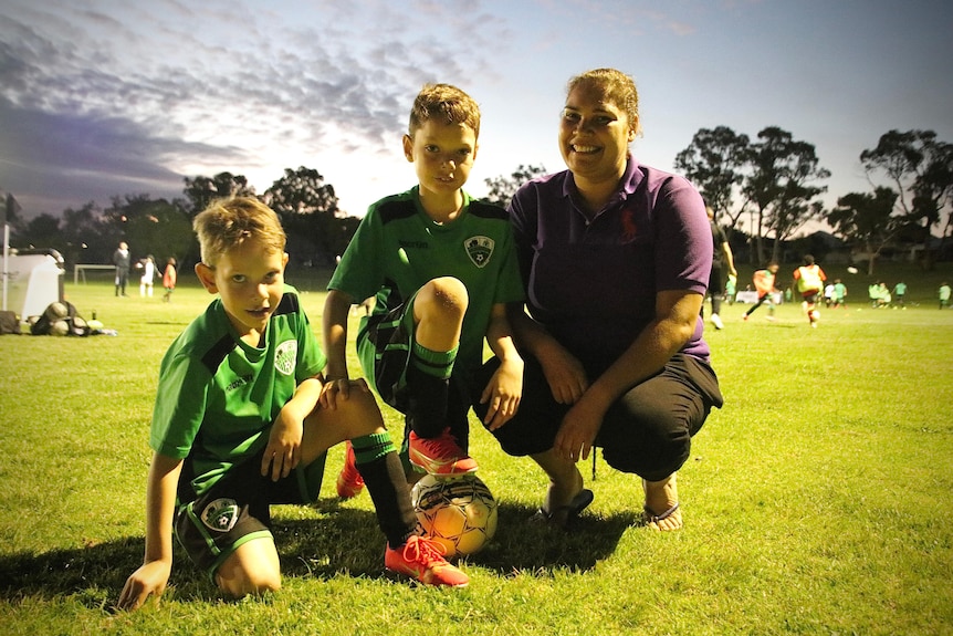 Chase and Zion Foster-Knighton in their soccer gear with Kiara Govan