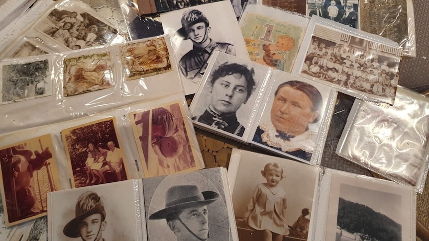 Old photos in albums including sepia and military portraits.