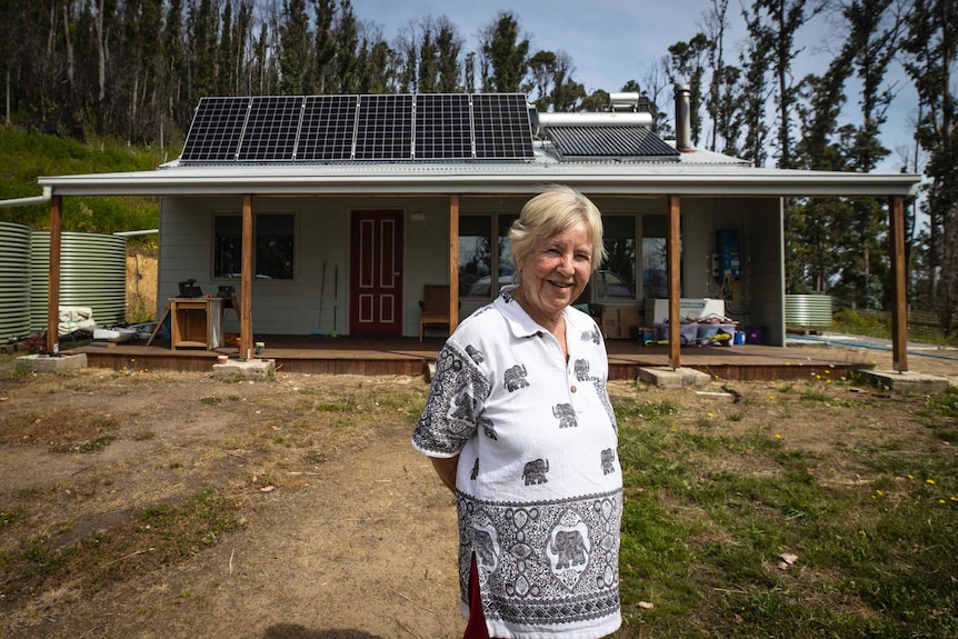 Rita Helling standing in front of her kit home.