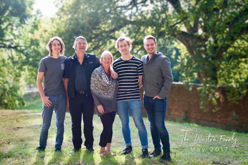 Joanne and Mick Westra and their three sons pose for the camera.