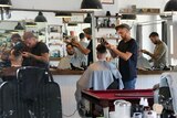 Barbers cut hair at Westons barber shop in William Street in Perth 4 March 2015
