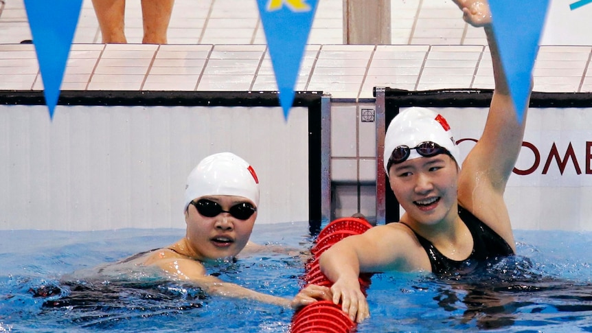 Ye Shiwen (R) celebrates with team mate Li Xuanxu after winning gold and bronze in 400IM.