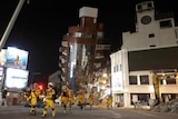 Firefighters complete their mission and evacuate from the collapsed building after a quake.