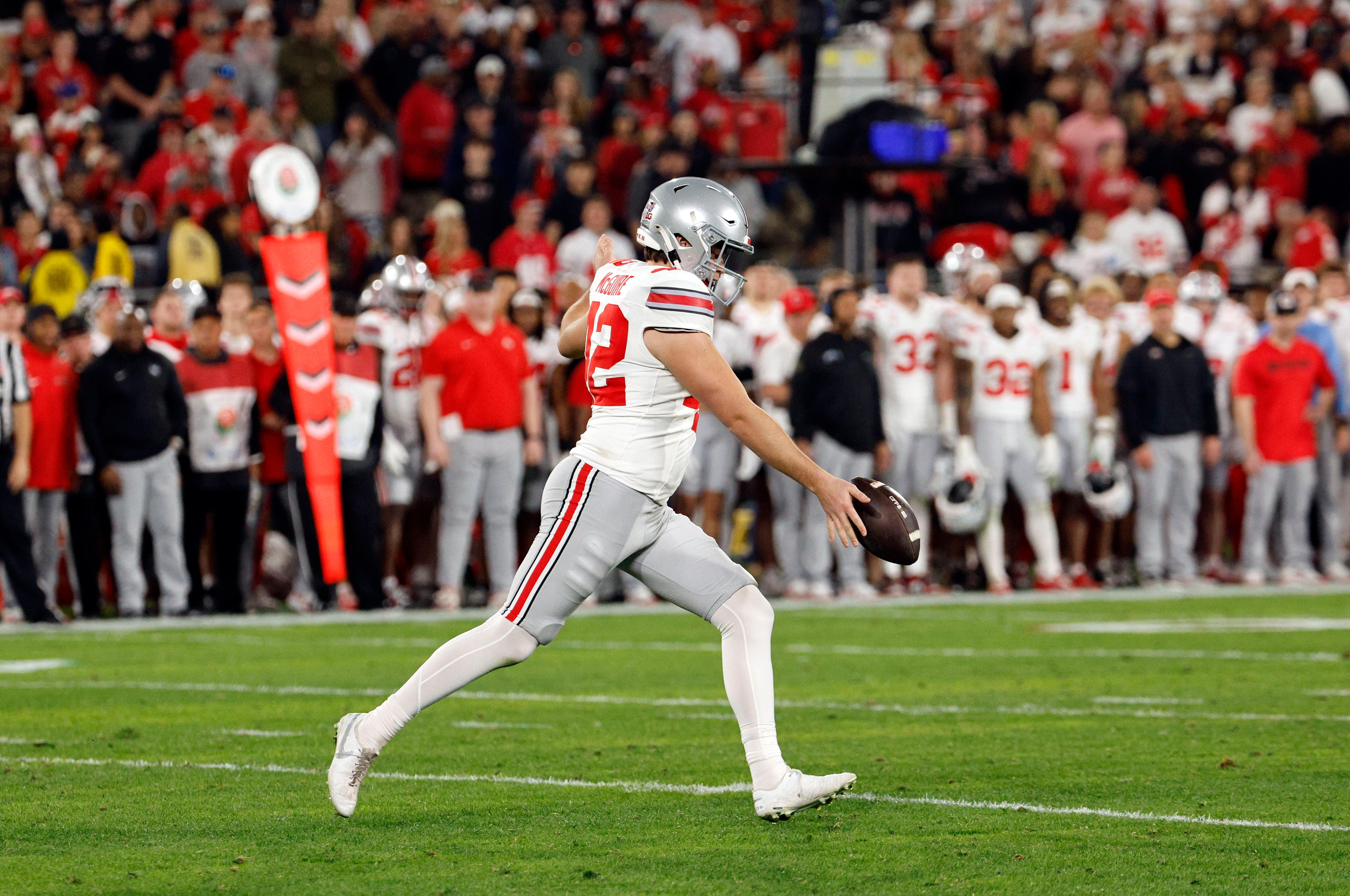 A man punts the ball during an American football match