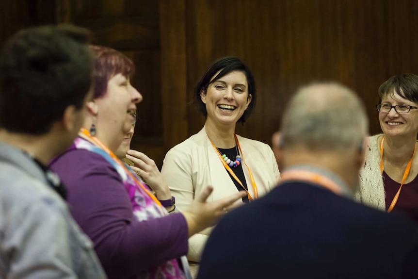 Reverend Whitaker laughs with other Uniting Church members