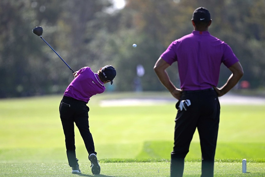 Tiger Woods watches his son, Charlie, play a shot off the tee