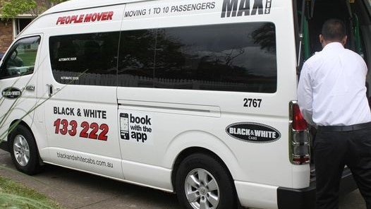 Black and White Cabs van with driver at back with boot open