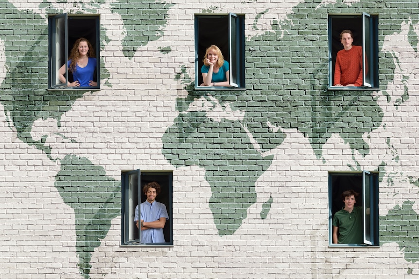 People look out their windows and smile, with a backdrop of the world painted on their building.