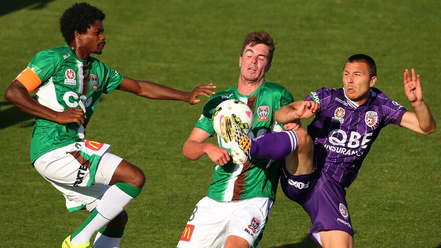 Nebojsa Marinkovic of Perth Glory contests the ball against Perth's Kew Jaliens and Allan Welsh.