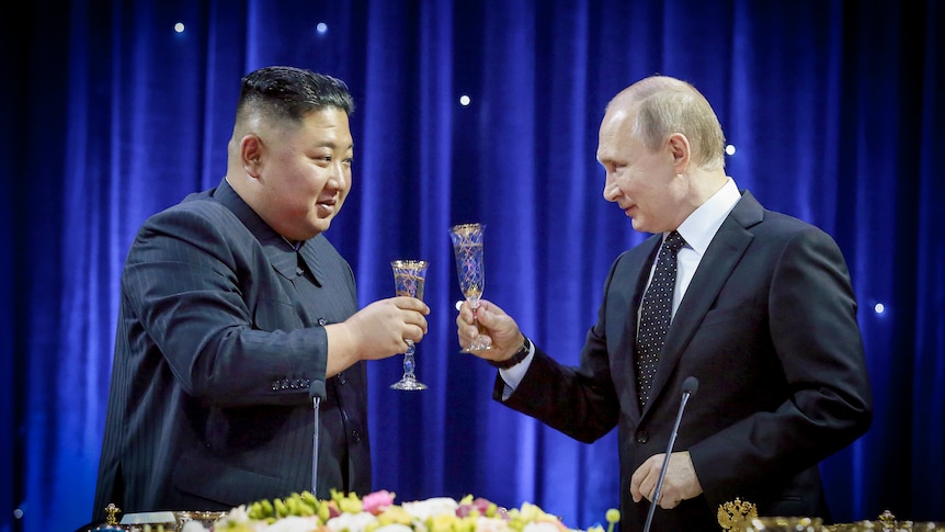 Vladimir Putin and Kim Jong Un toasting champagne floats and smiling at each other 