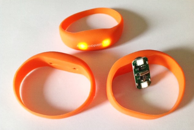 A picture of the wristbands and battery insert accessible through a slit on the back.