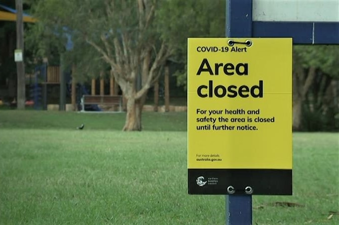 A yellow sign reads: "COVID-19 Alert: Area closed".