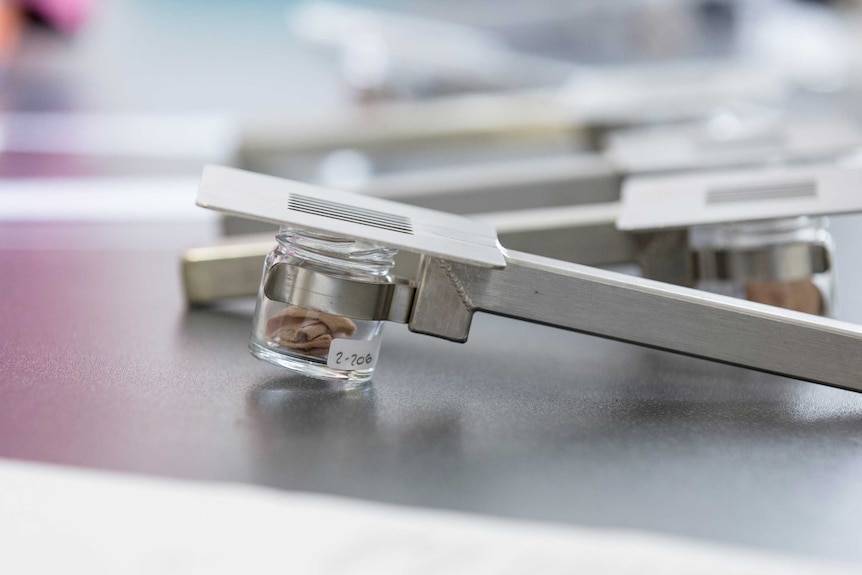 Close up of sample jar and testing apparatus in lab