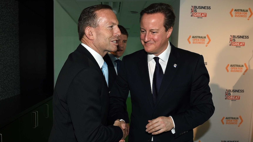 Tony Abbott shakes hands with UK prime minister David Cameron in Sydney.