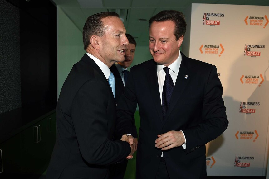 Tony Abbott shakes hands with UK prime minister David Cameron in Sydney.