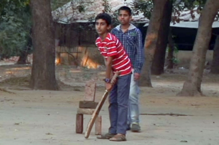 Boys play cricket in south Delhi