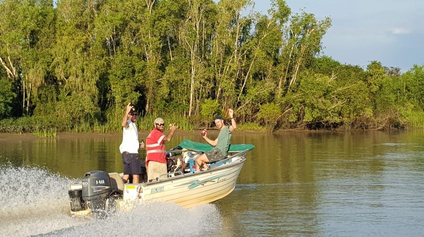 Men in boat on a river in the NT