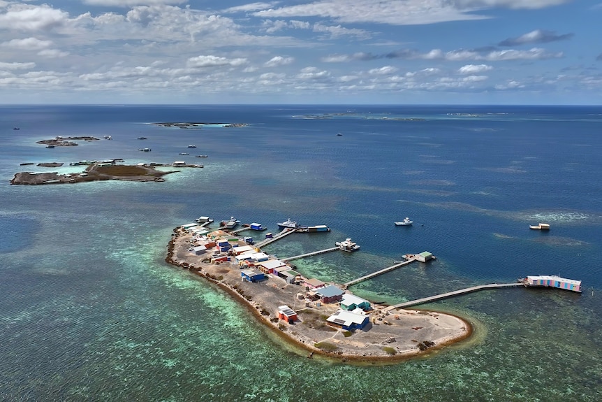An aerial of a small island with several pontoons.