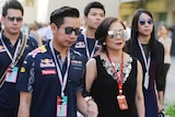 Family in Red Bull merchandise walks in crowd