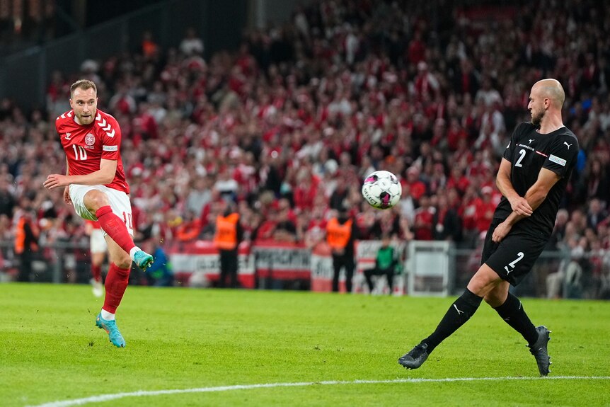 Danish footballer Christian Eriksen takes a shot during an international match.
