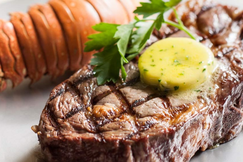 A cooked steak on a plate.