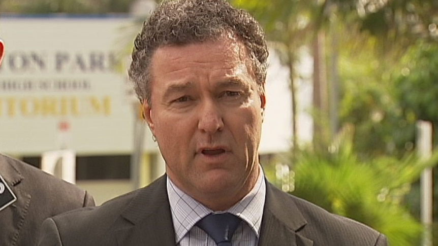 Education Minister John-Paul Langbroek makes the announcement outside Brisbane's Everton Park State High School, which will remain open.