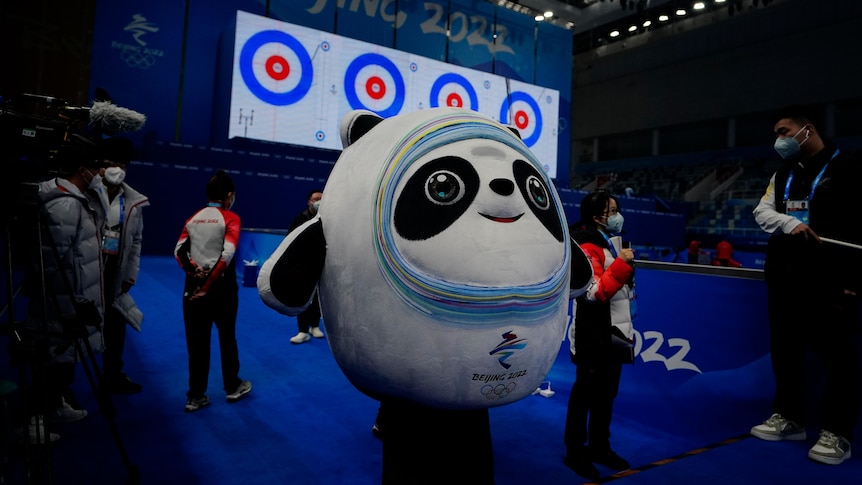 A big panda mascot stands inside the Winter Olympics curling centre