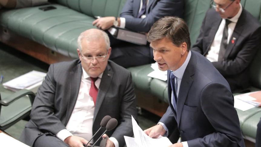 Angus Taylor speaks at the House of Representatives despatch box as Scott Morrison watches on