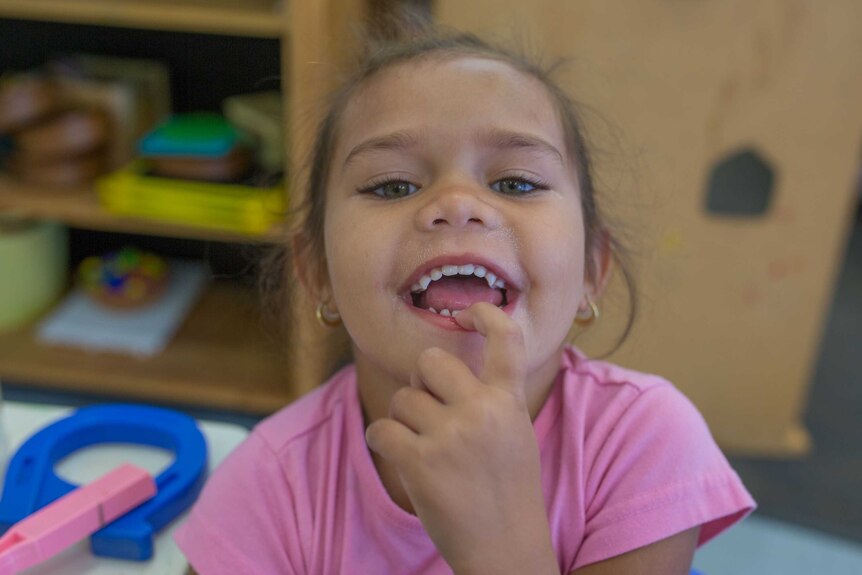 A girl grins for the camera at Lulla's.