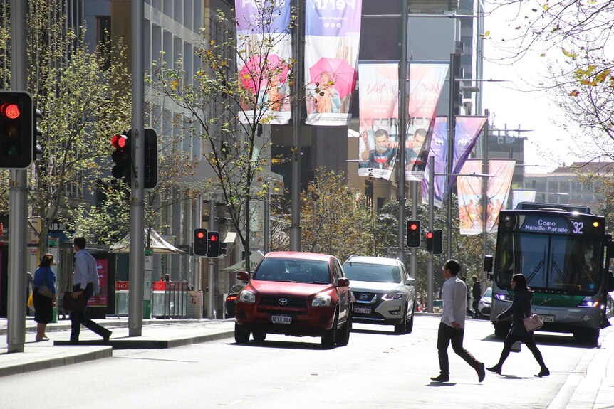 Traffic and pedestrians on St Georges Terrace in Perth.