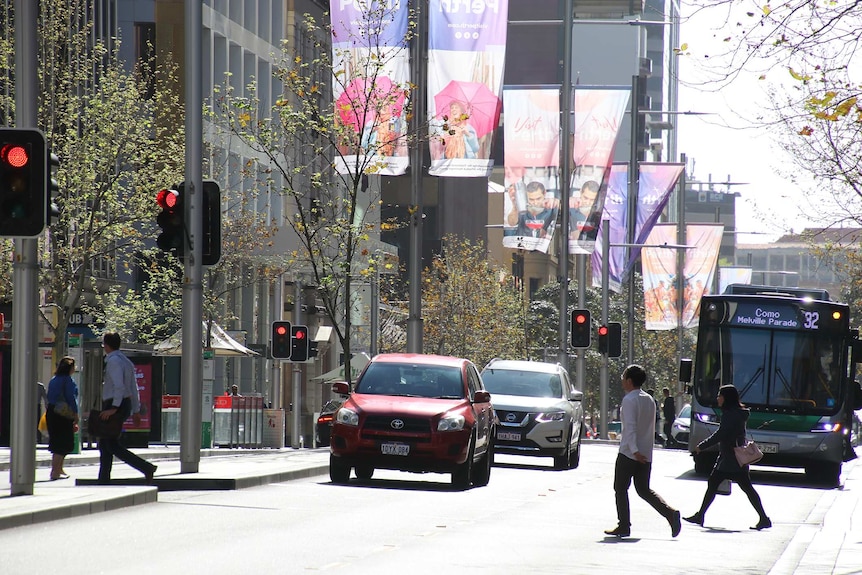 Traffic and pedestrians on St Georges Terrace in Perth.
