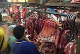 Butchers in wet markets in Indonesia carve up beef during Ramadan. 2016.