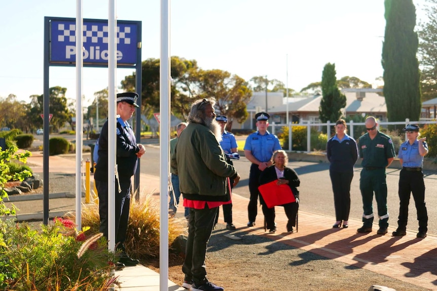 A man stands in front of an audience at the police station in Norseman WA.