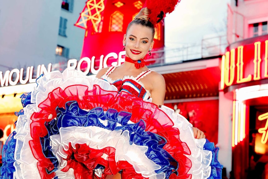 Moulin Rouge dancer stands outside the cabaret