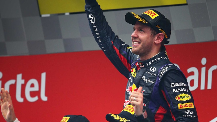2013 F1 world champion Sebastian Vettel is lifted up by Nico Rosberg and Romain Grosjean.