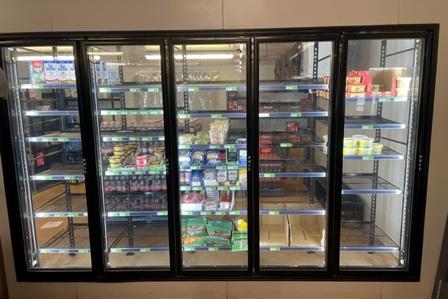 a fridge with only half the shelves occupied by food