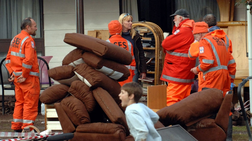 SES workers talk to a flooding victim in Gippsland