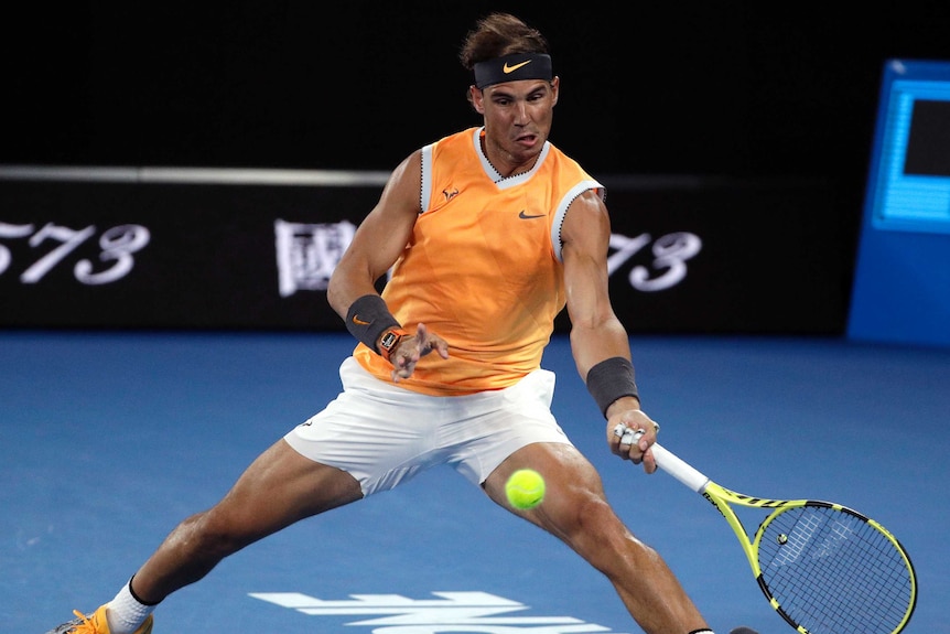 Rafael Nadal scrambles a shot off the baseline against Matt Ebden at the Australian Open