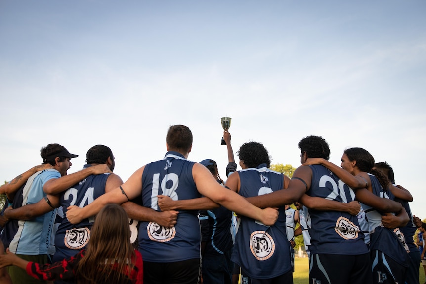 A team holds a trophy high