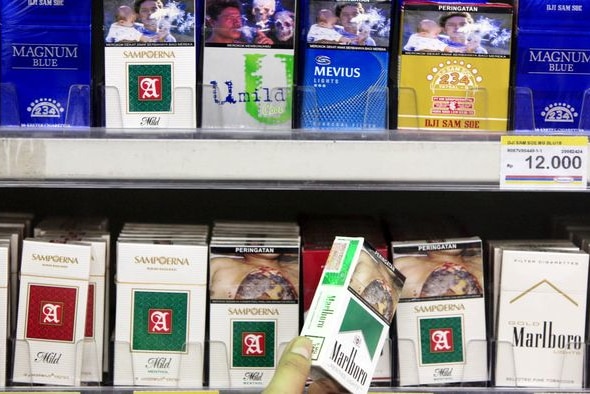 Indonesian cigarette packages displayed in a store.