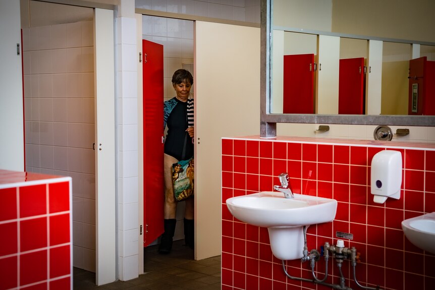 Rebecca Smyth shuts the door to a cubicle in the women's change rooms at her local pool.
