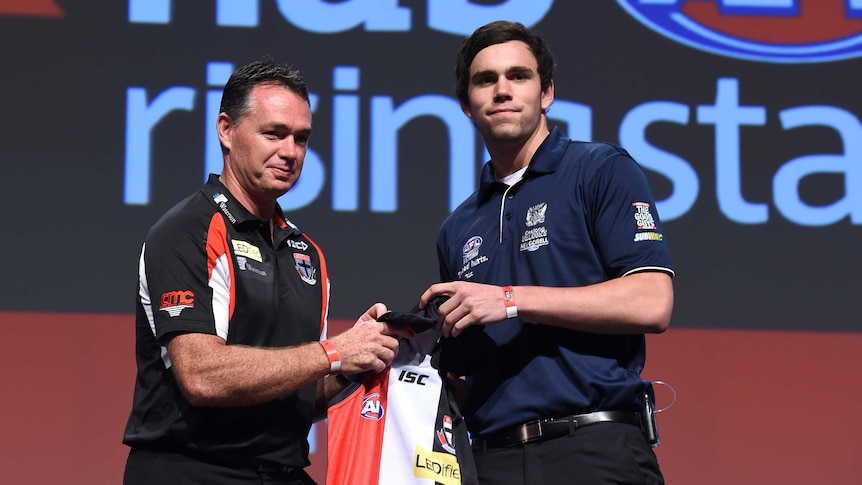 Paddy McCartin receives his St Kilda jumper from Alan Richardson