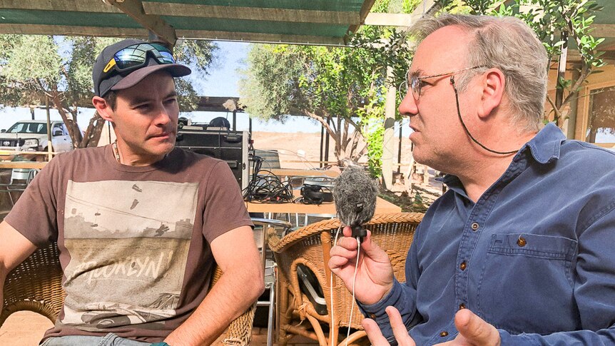 Peter Crawford sits talking to NSW Country Hour Presenter Michael Condon