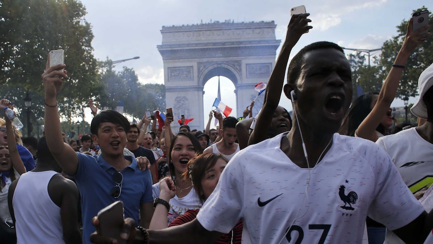 French fans celebrate on the Champs Elysees