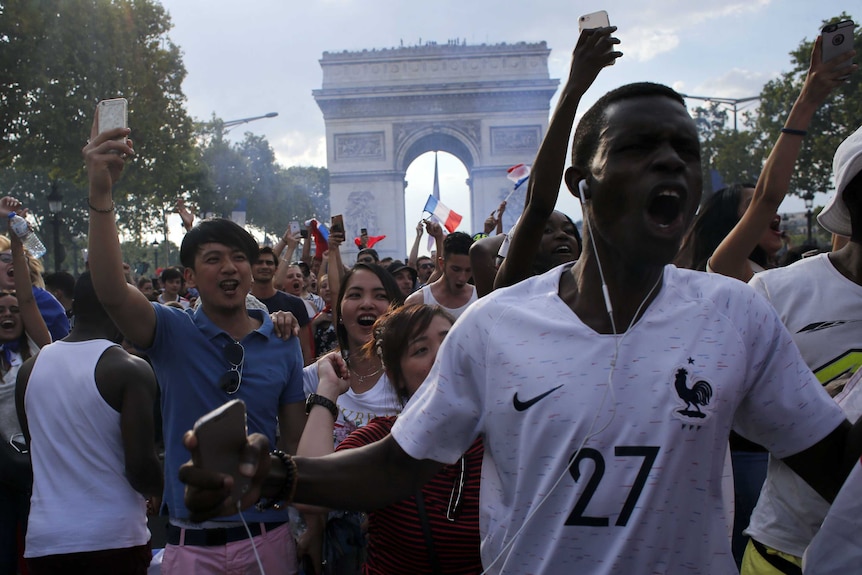 French fans celebrate on the Champs Elysees