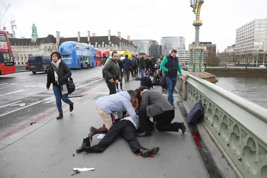 Injured people are assisted after an incident on Westminster Bridge in London