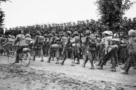 Australian soldiers walk back to their billets after fighting on the frontlines.