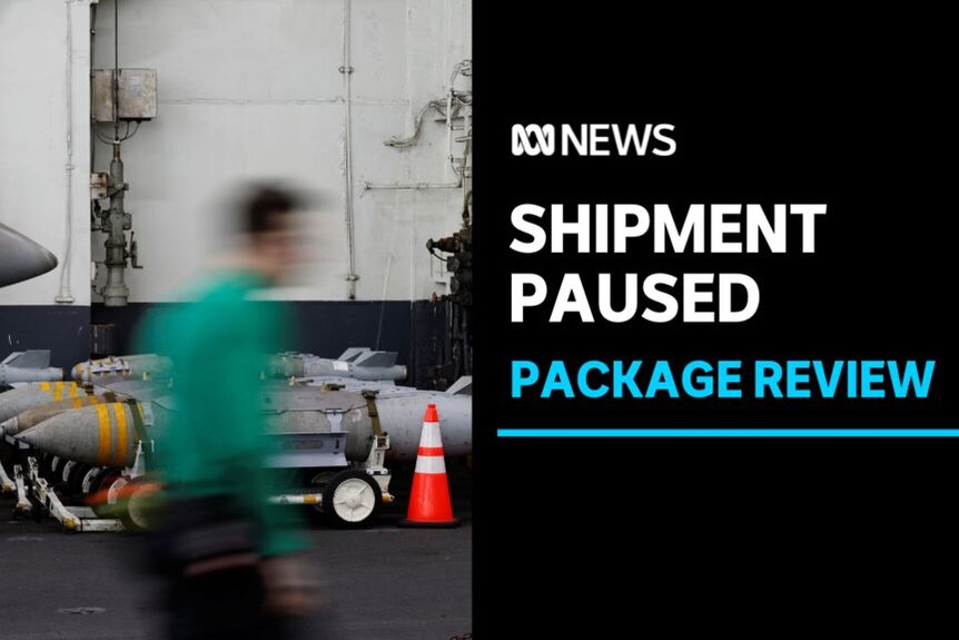 Shipment Paused, Package Review: A person walks in the foreground with movement blur with bombs on trollies in the background.