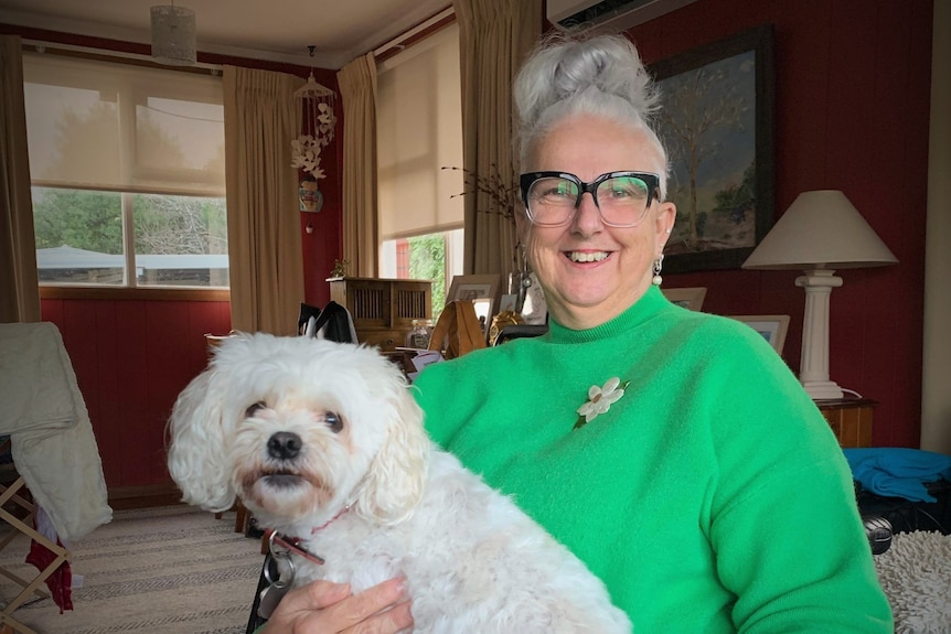 Tammy Milne with a dog in her lap.