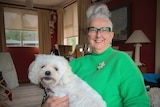 Tammy Milne with a dog in her lap.